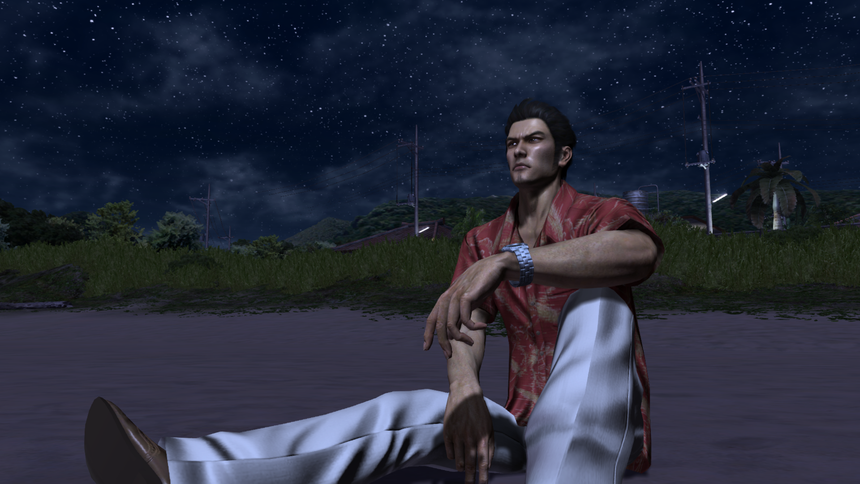 Kiryu sitting at the beach, looking off into the distance