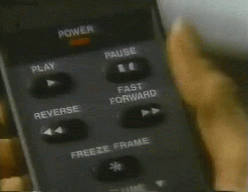 a person is pressing fast-forward on a remote control
