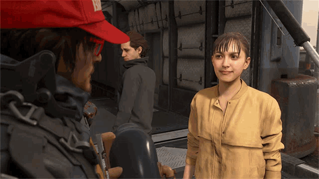 man wearing a red BRIDGES hat talks to a woman who is giving a double thumbs up